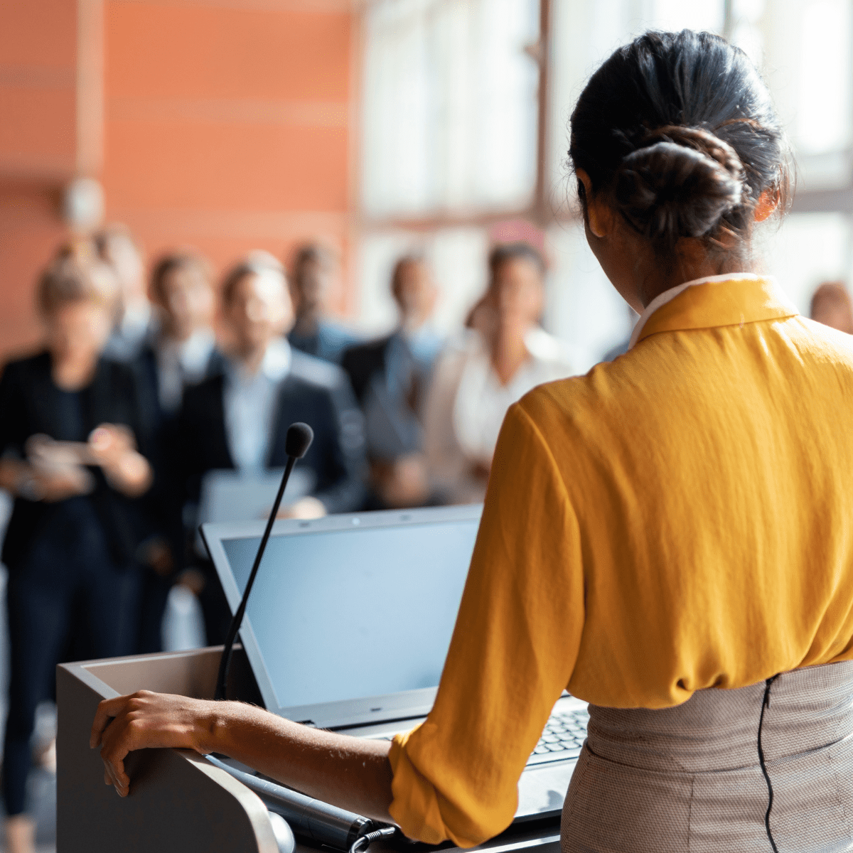 Woman giving speech in front of a small crowd